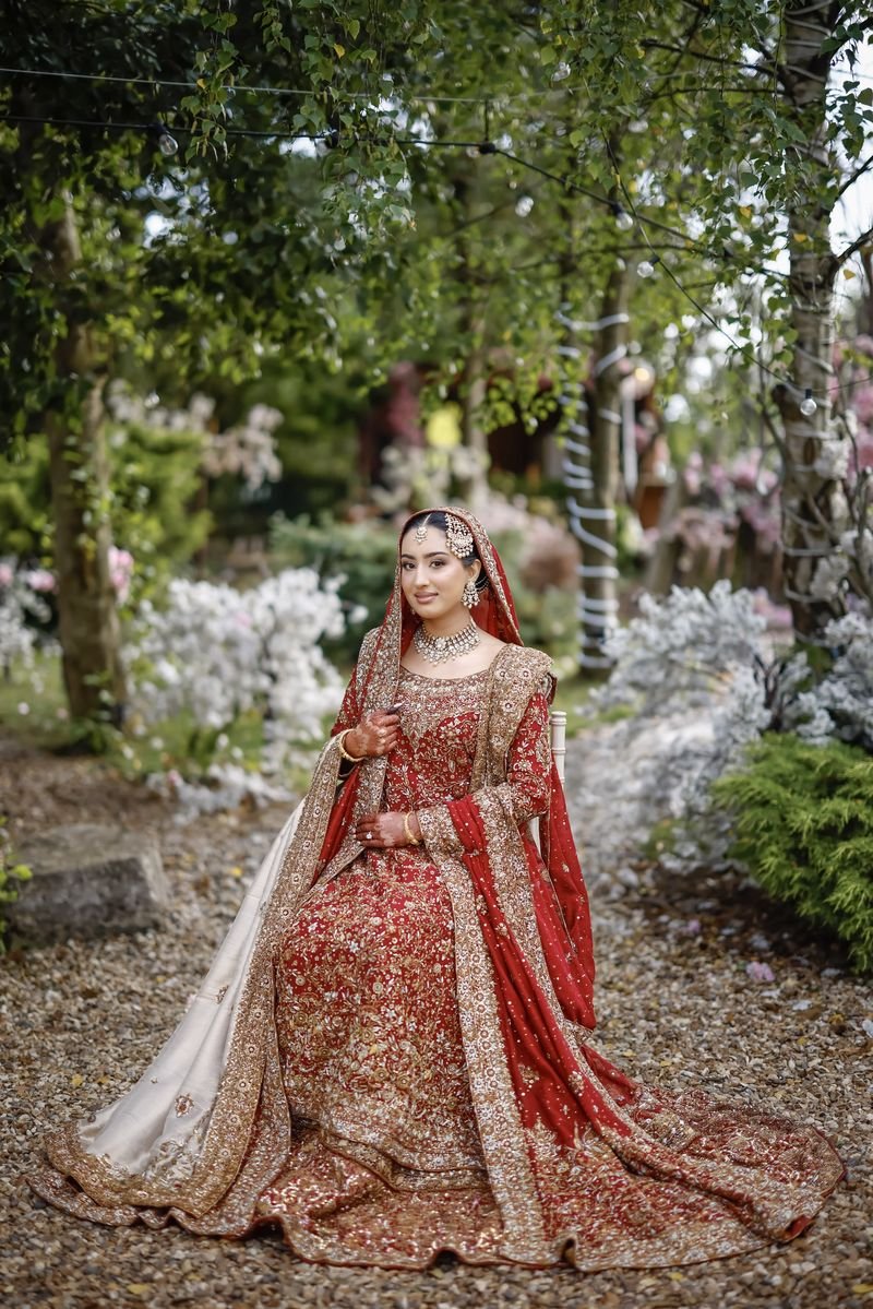 Bride in red in a garden
