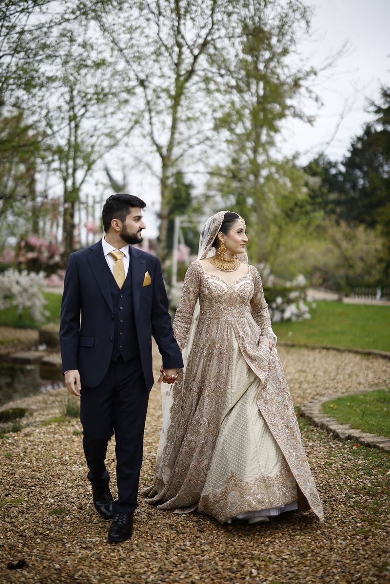 Bride and groom walking in a garden
