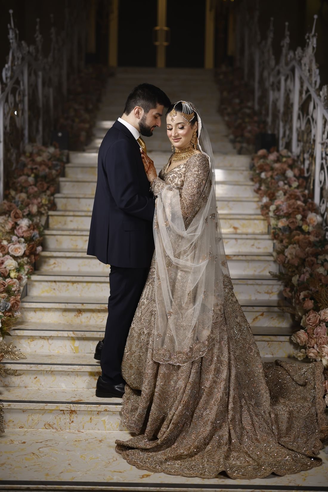 Bride and groom on a grand staircase