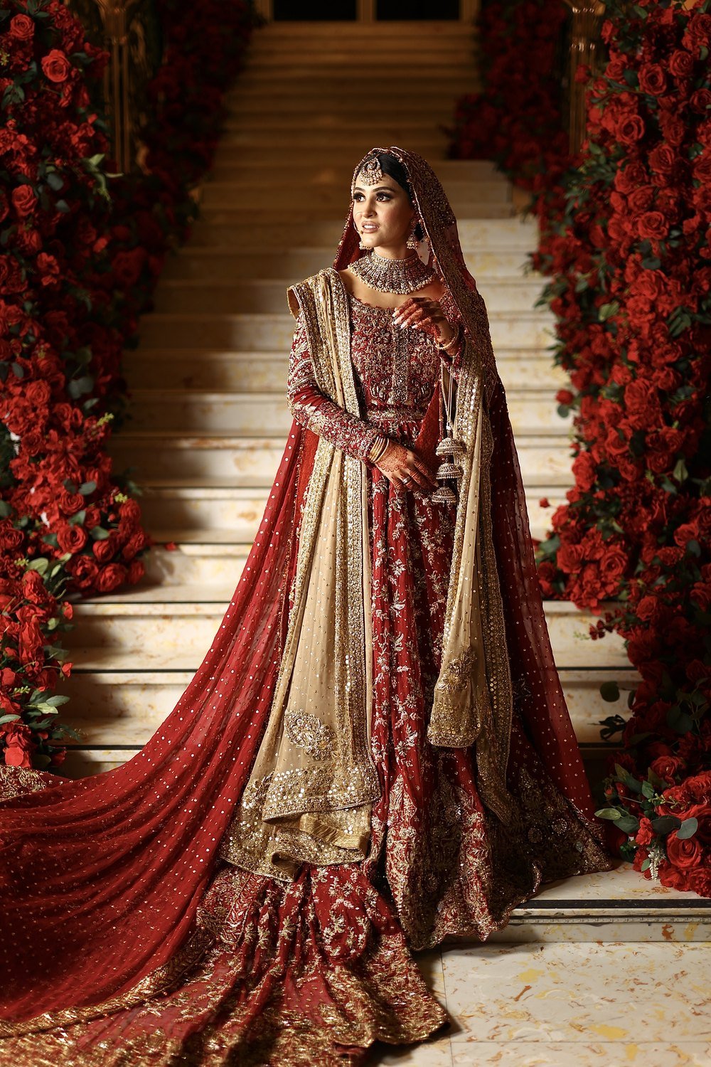 Bride on the red-rose staircase at The Excellency